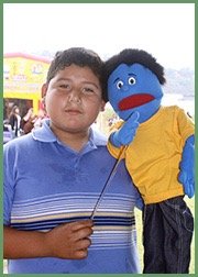Boy with the puppet Blue, who is Blue, who feels blue, and whose name is blue.